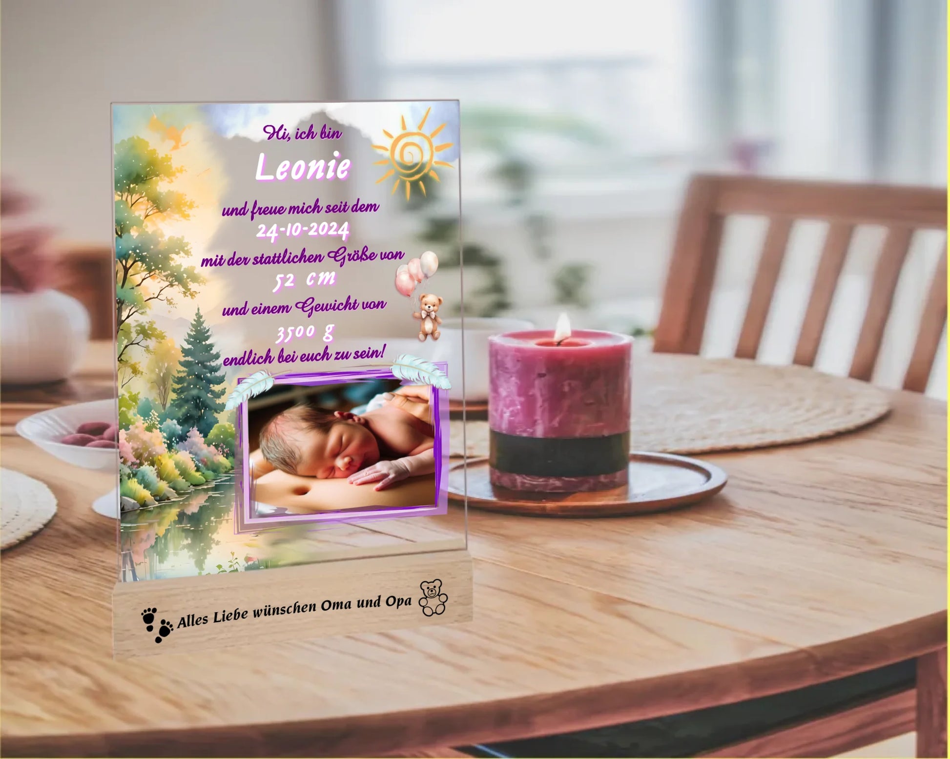 acrylglas-fotoaufsteller-15x20cm-mit-graviertem-standfuß-aus-holz-personalisierter-steckbrief-mit-geburtsdaten-und-foto-hauptfarbe-des-designs-pink-und-pasteltoene-standfuss-mit-wunschtext-graviert-fotoauftseller-steht-auf-esstisch-neben-einer-kerze