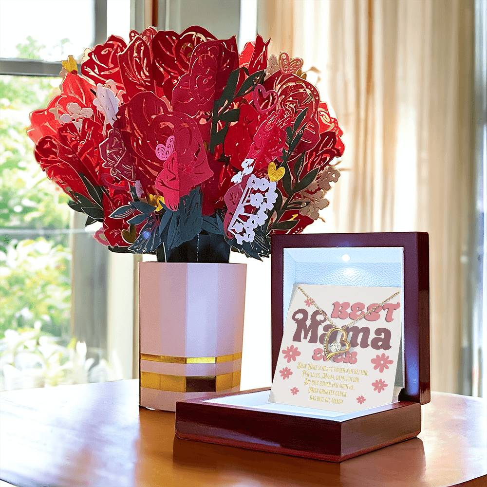 halskette-mit-herzanhänger-und-zirkonia-mit-gelbgold-finish-in-einer-geschenkbox-aus-holz-mit-grußkarte-best-mama-ever-neben-einem-karton-blumenstrauss